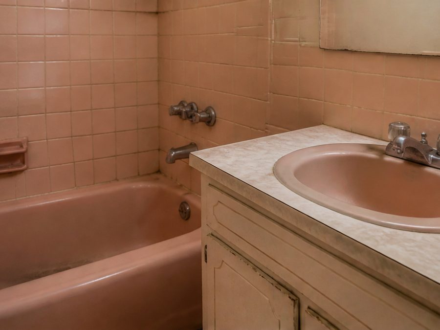 A dated, worn bathroom, illustrating the kind of condition JT buys in